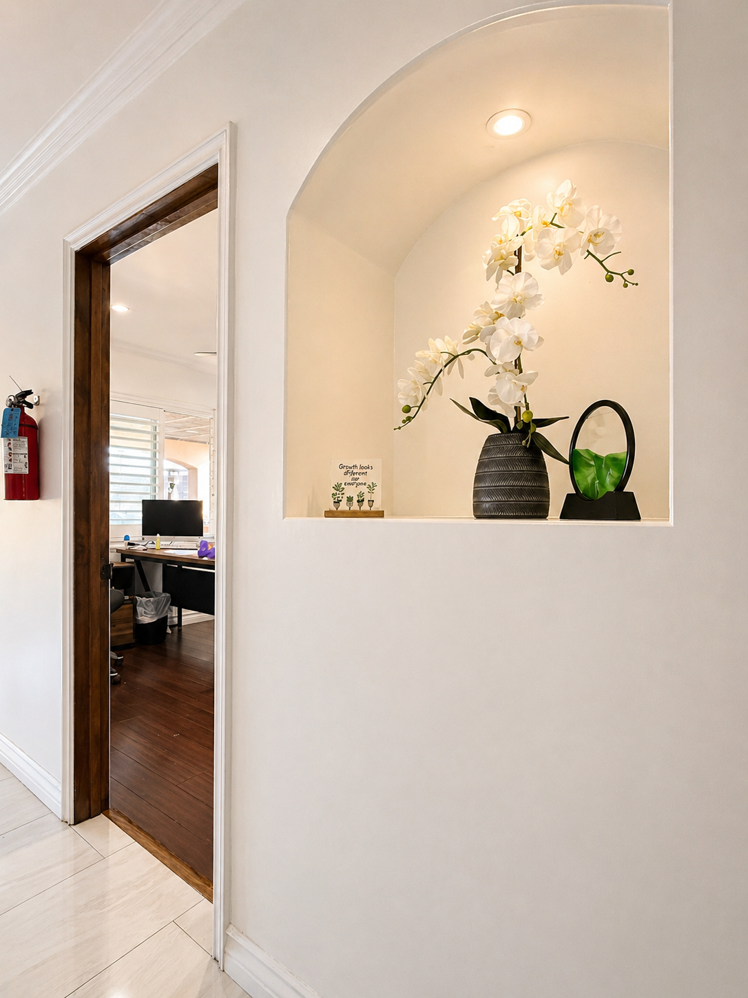 Architectural wall niche with white orchid arrangement and decor