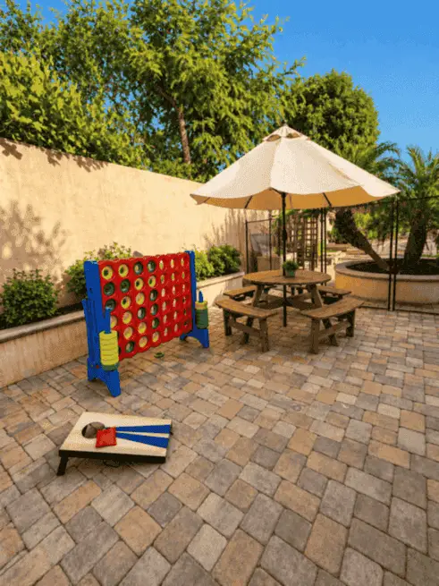Outdoor games and shaded table area in the backyard
