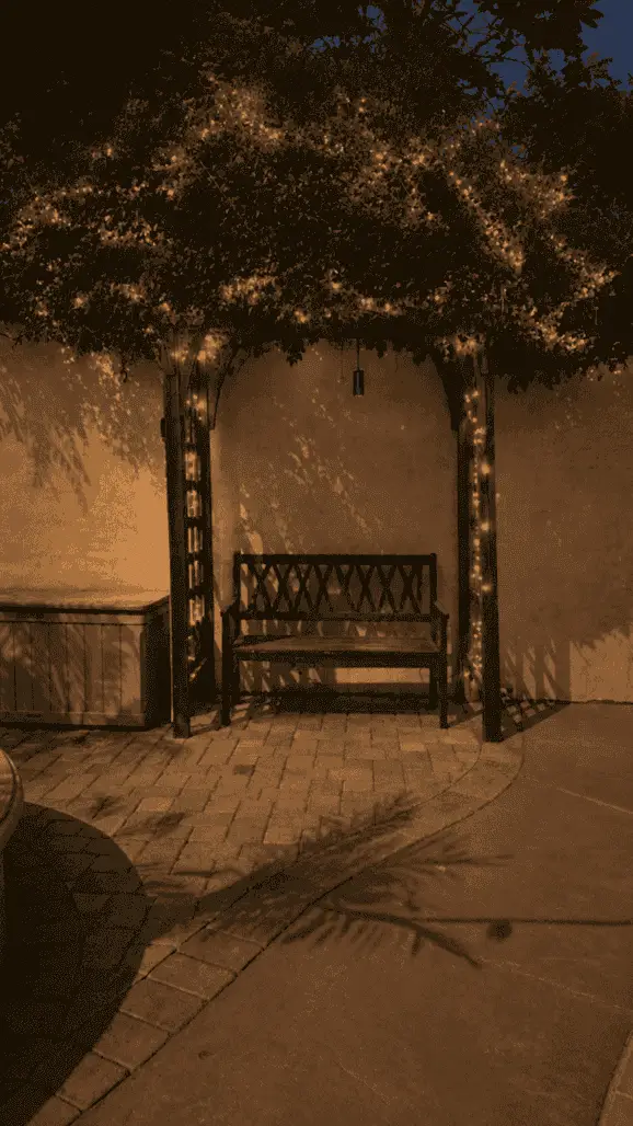 Pergola bench with string lighting in the evening