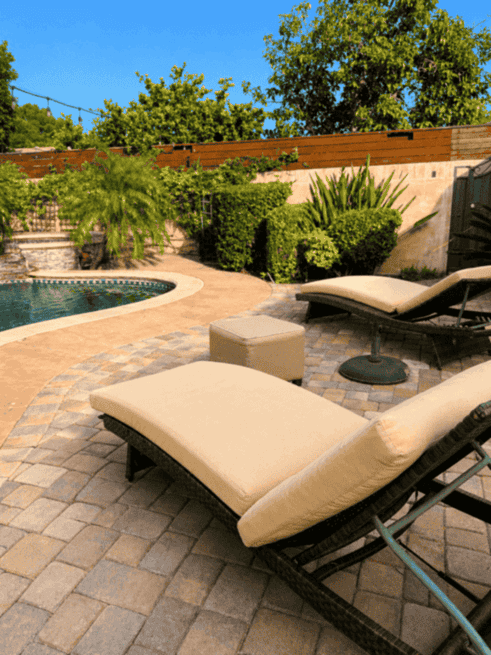 Backyard pool and lounge area during the day
