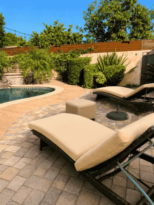 Backyard pool and lounge area during the day
