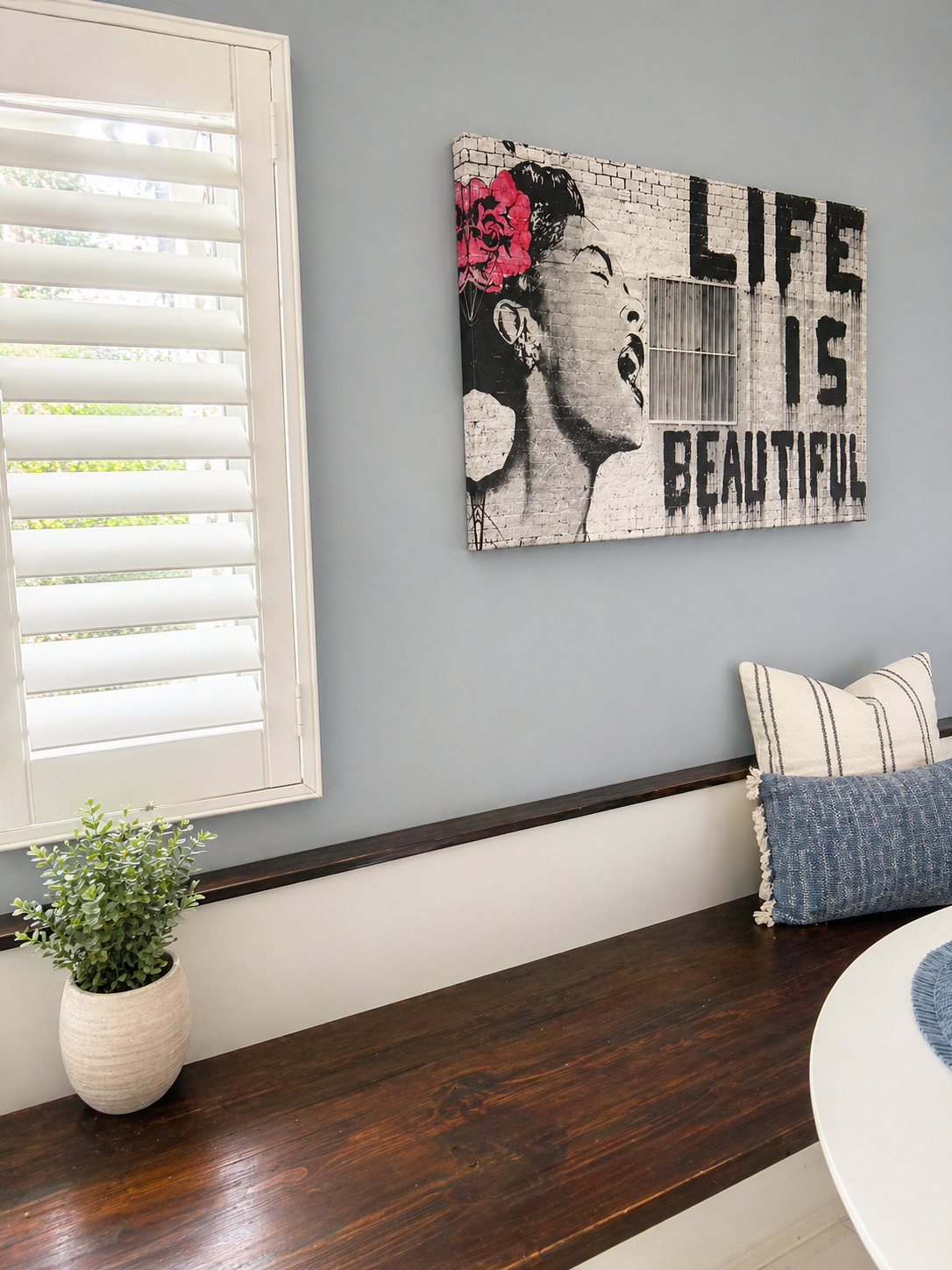 Built-in wood bench seating beside dining area
