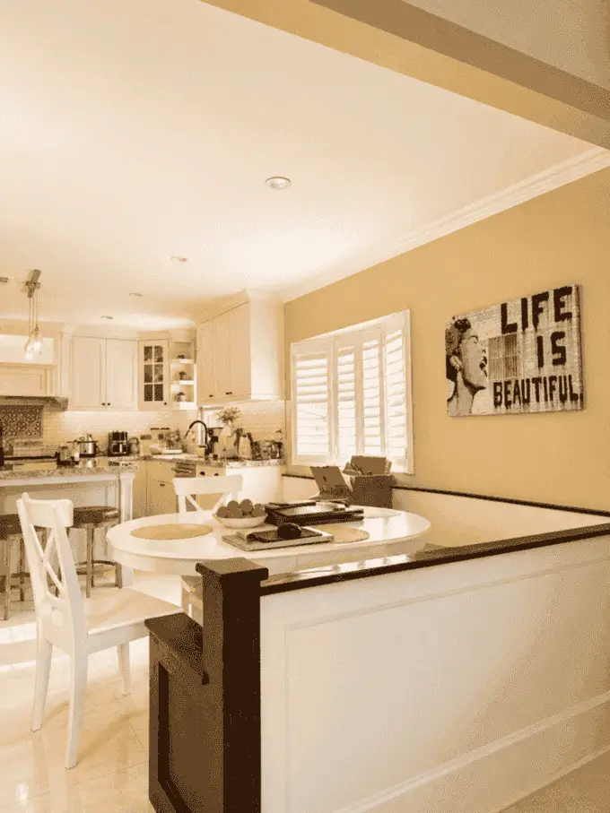 Breakfast nook with round table next to kitchen