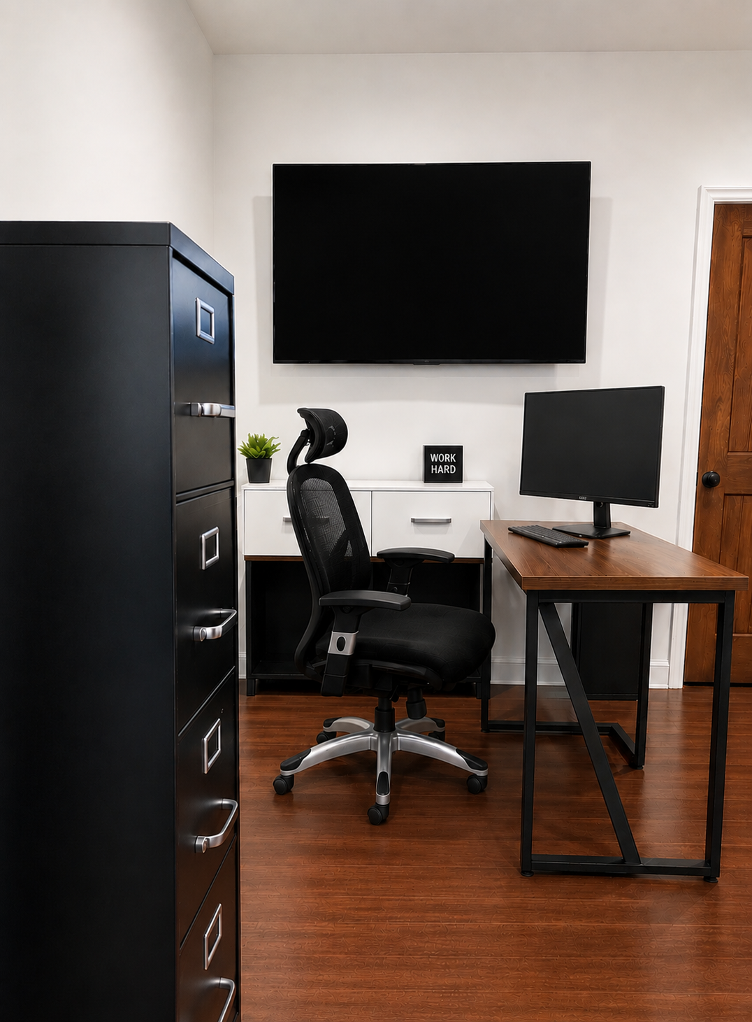 Main office with desk, ergonomic chair, and wall-mounted screen