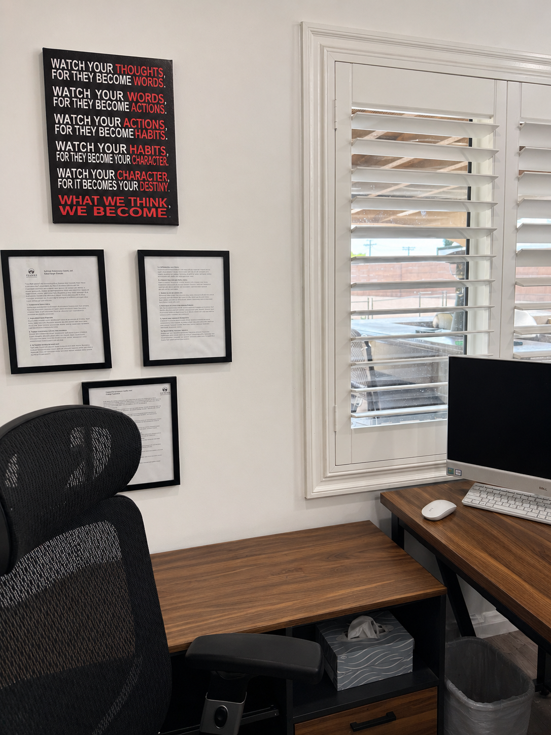 Therapy office desk with motivational wall art and shuttered window